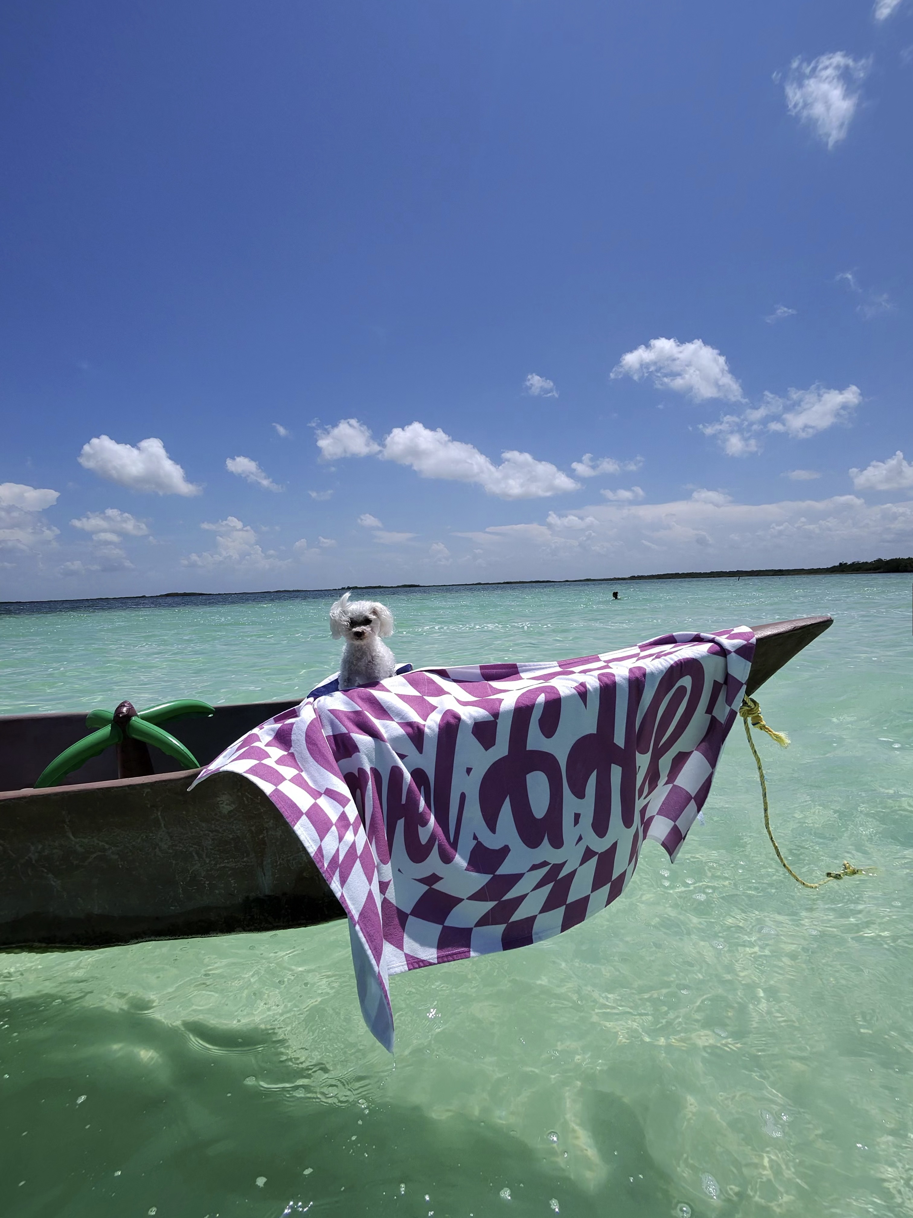 Wooden boat on a shallow turquoise lagoon in Holbox, Mexico
